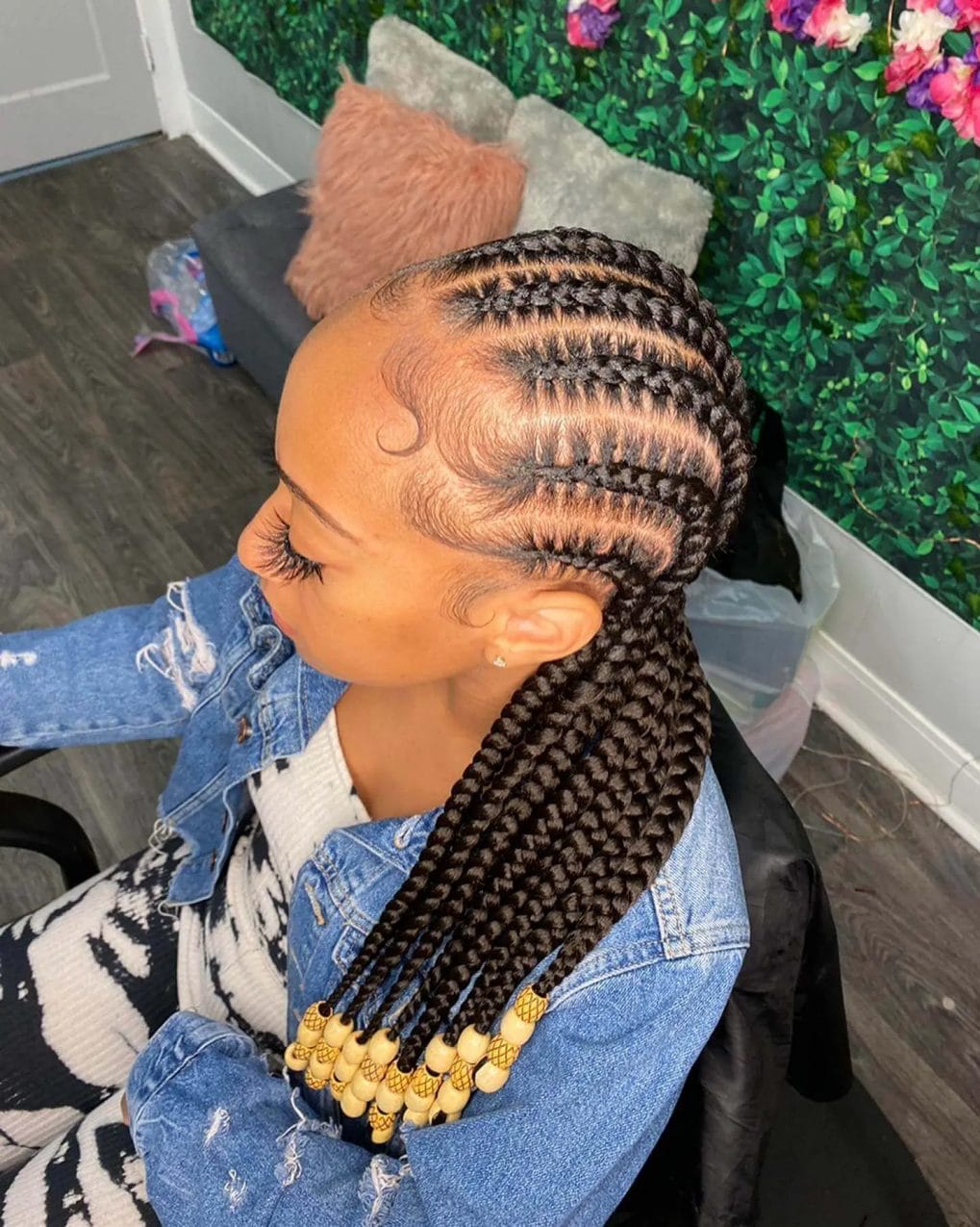 Thick, smooth cornrows with glossy light wood beads, wrapping around the head.