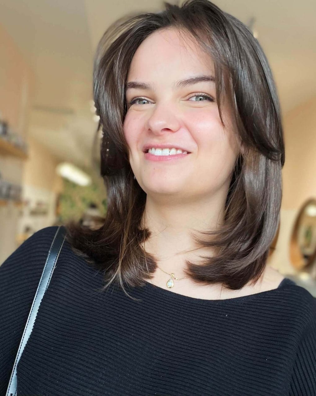 Smooth straight layers with trendy curtain bangs