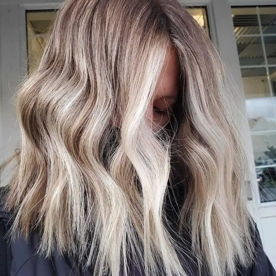 Mid-length ash-blonde balayage, mimicking the snowy landscapes of winter.