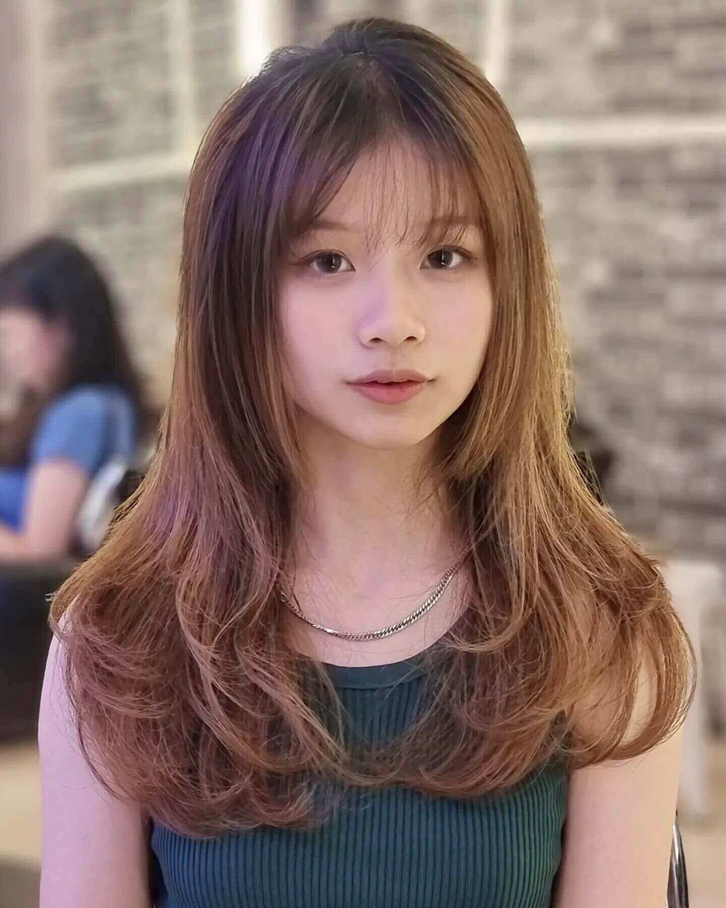 Soft layered medium-length hair with see-through bangs