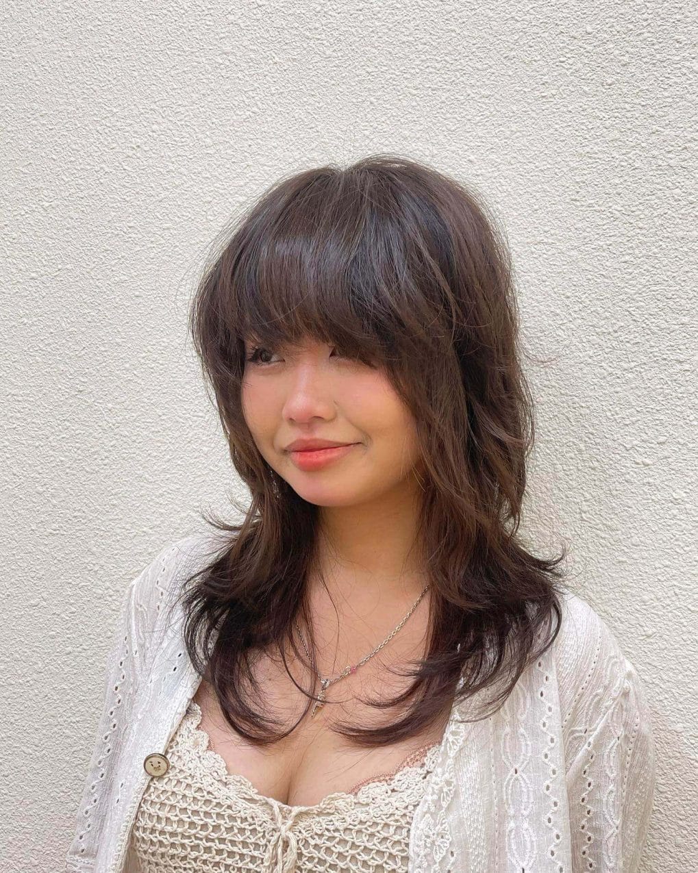 Soft layered cut with wispy waves and gentle fringe