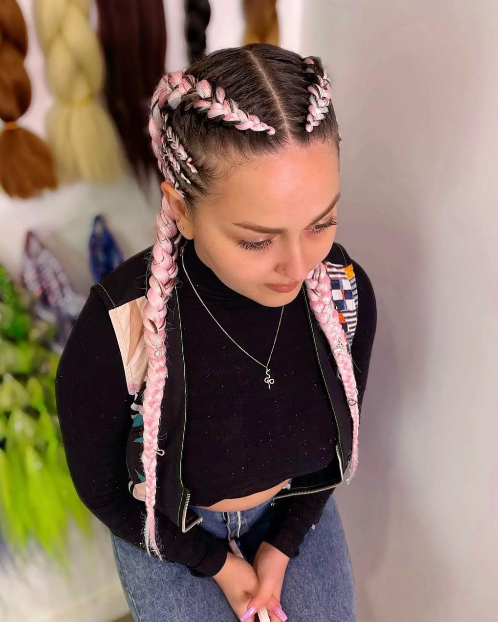 Neat Dutch braids with soft pink extensions, blending classic braiding with festival color pops.