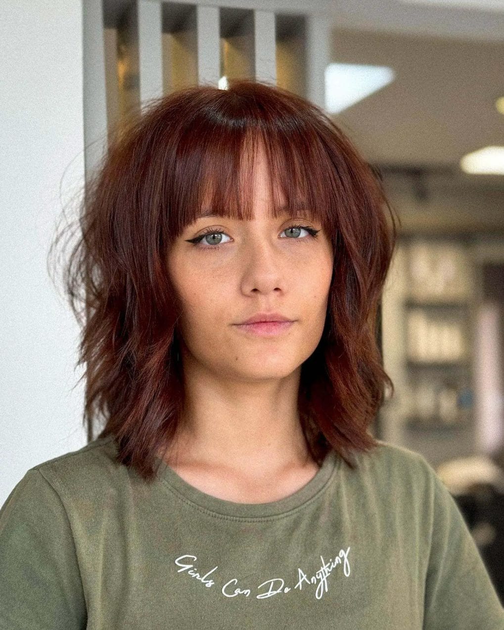 Sophisticated chestnut shaggy bob with full, straight-across bangs
