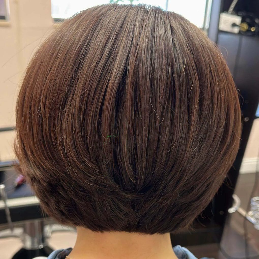 Sophisticated deep brown layered bob with a rounded head-framing silhouette.