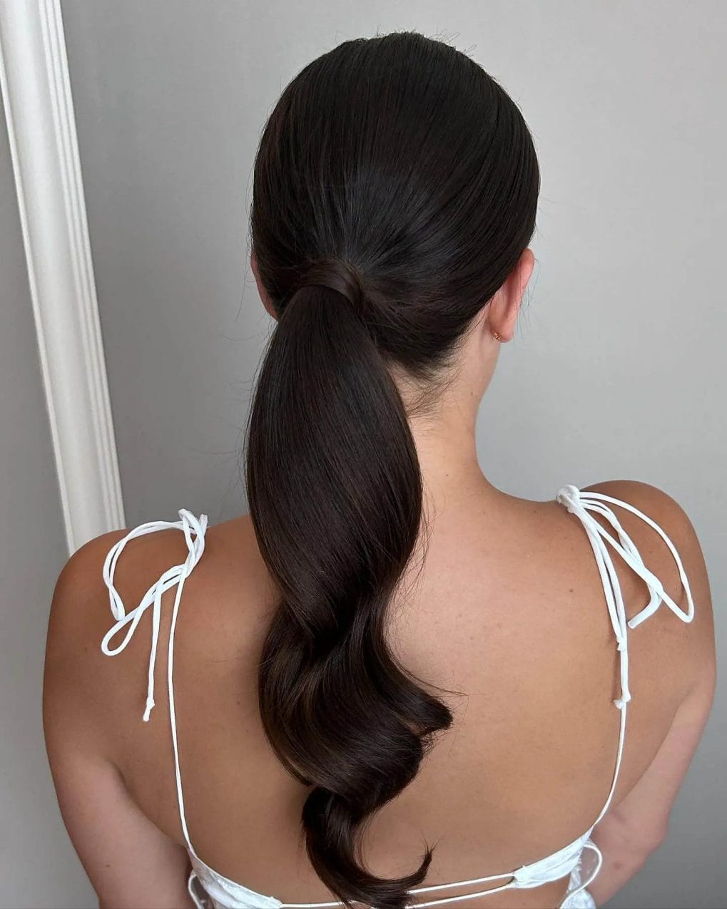 Elegant low ponytail with subtle neck twist