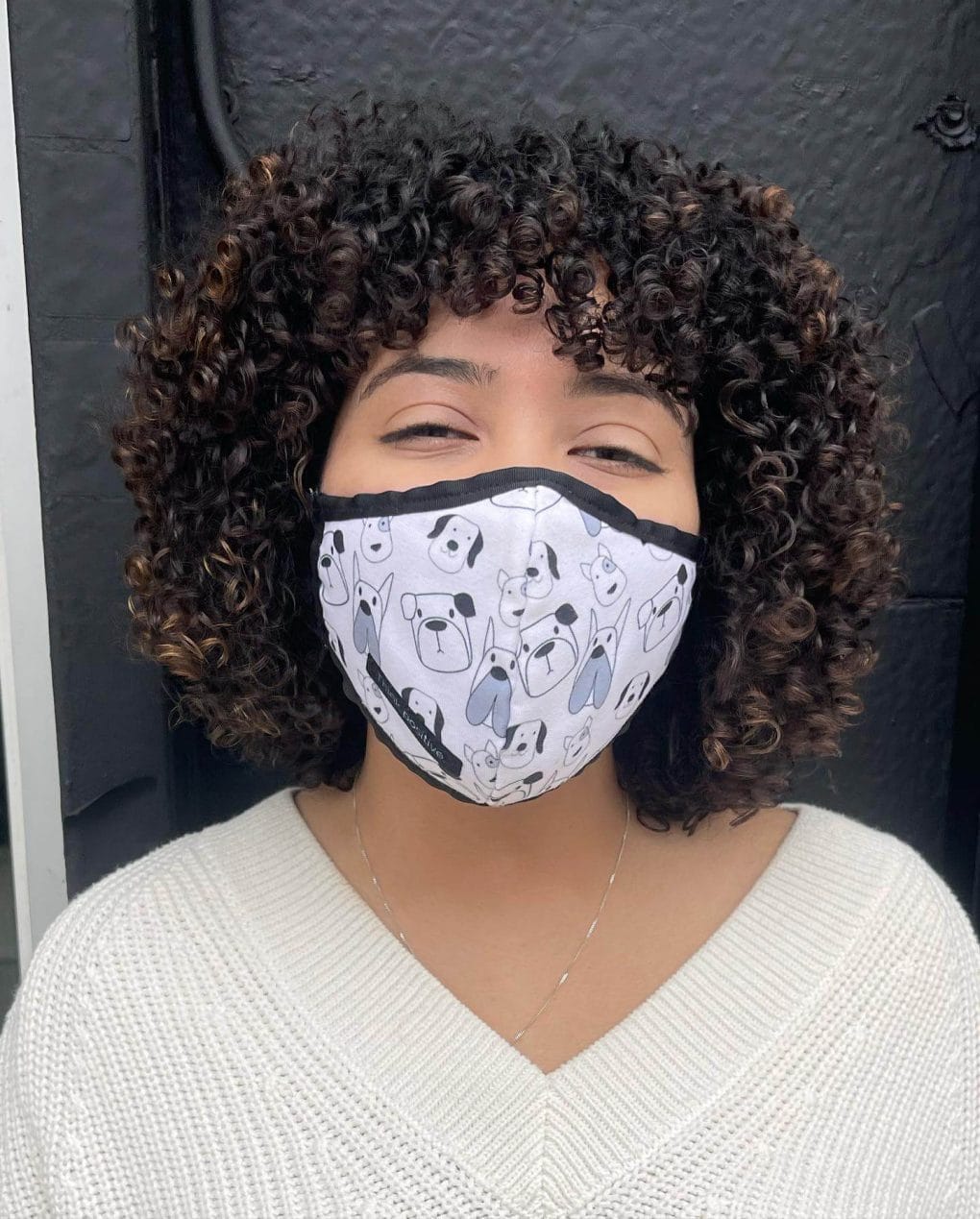 Short, bouncy perm with spiraled curls below the ears.