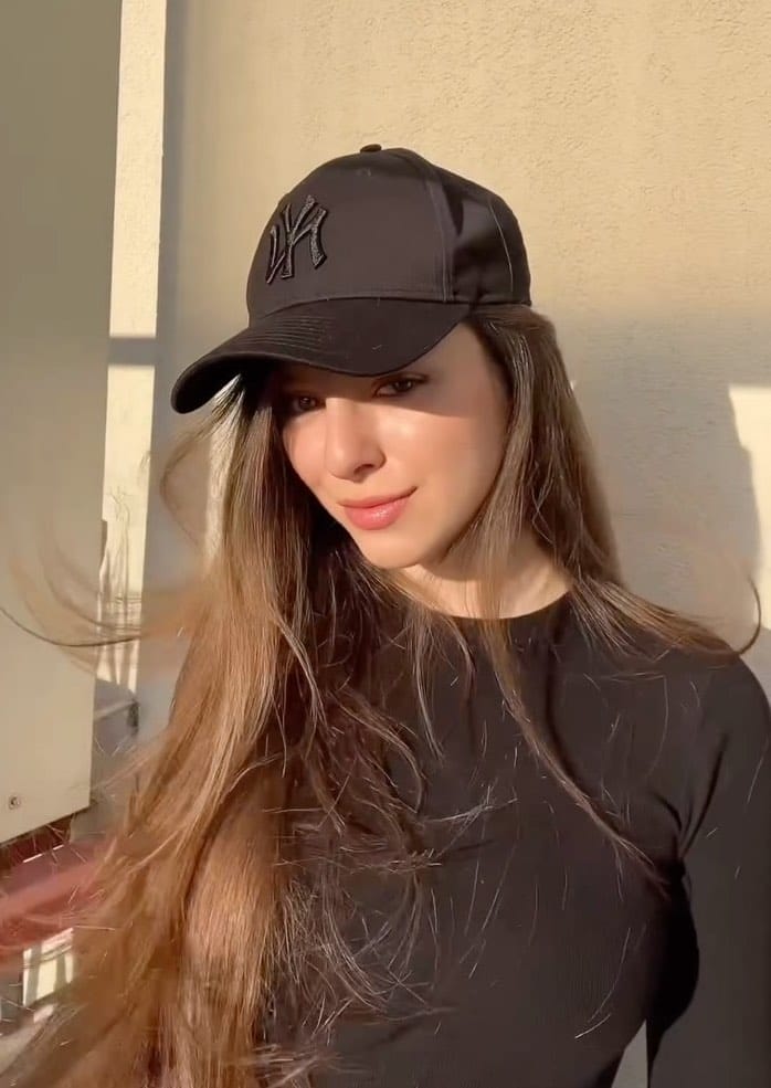 Straight hair under a cap in brunette for an effortless softball appearance