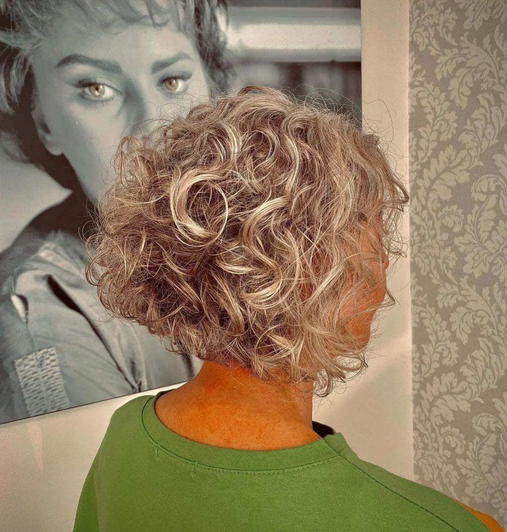 Stunning curly bob with ash blonde and caramel highlights.
