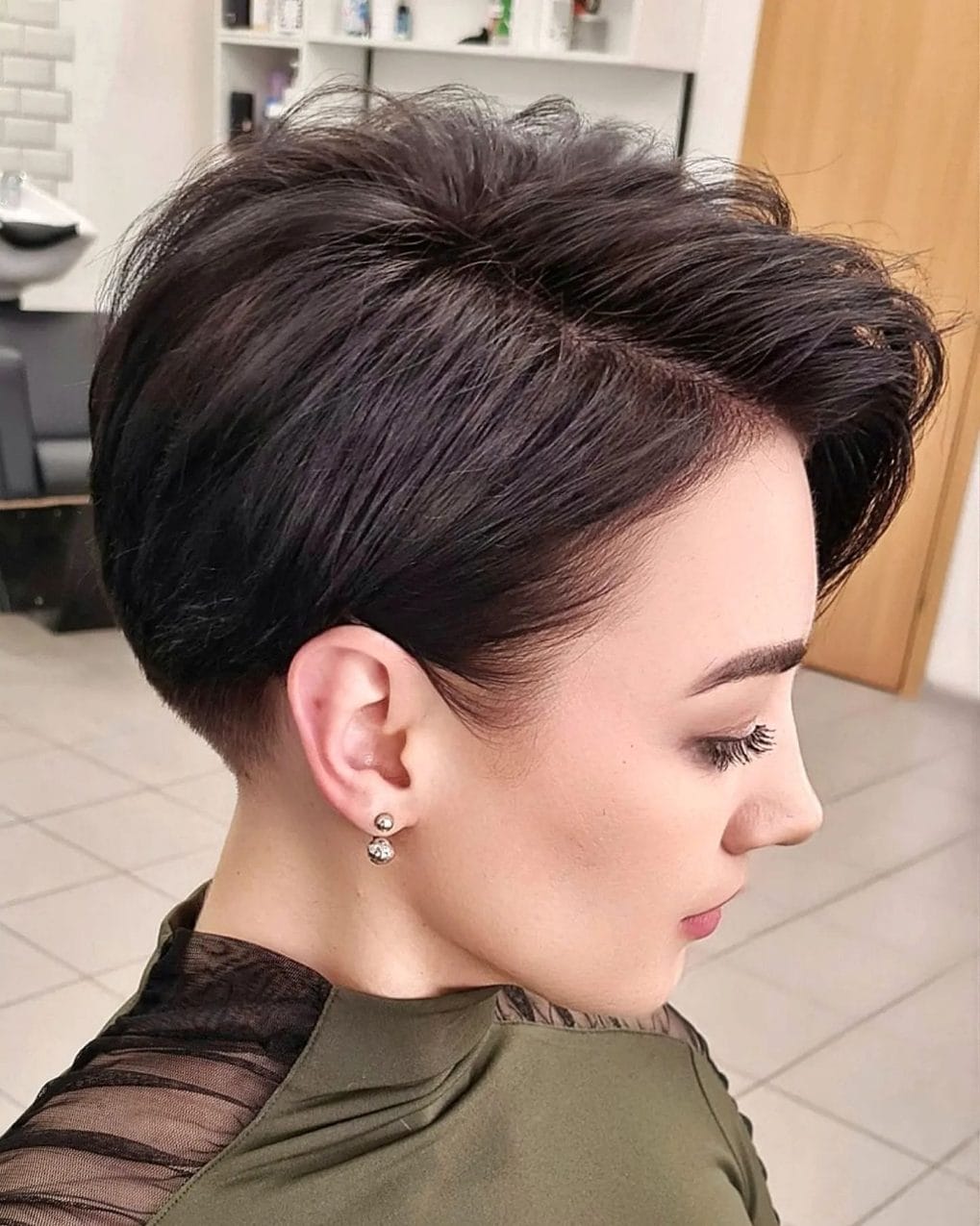 Classic pixie bob styled up and away from the face to highlight cheekbones with volume on top