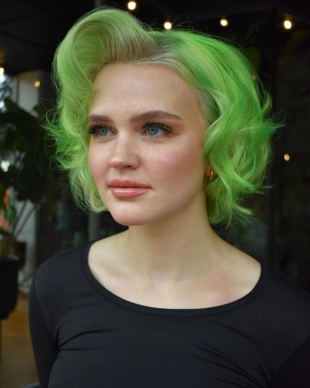 Fresh summer garden green short curls with dark roots peek