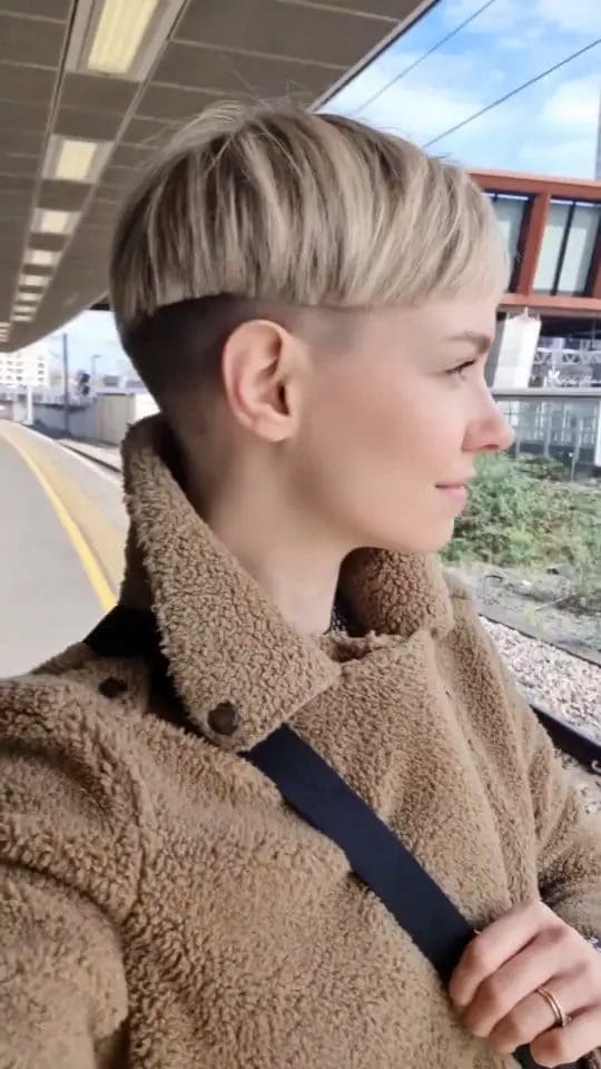 Shaved asymmetrical pixie with fuller top and blonde highlights