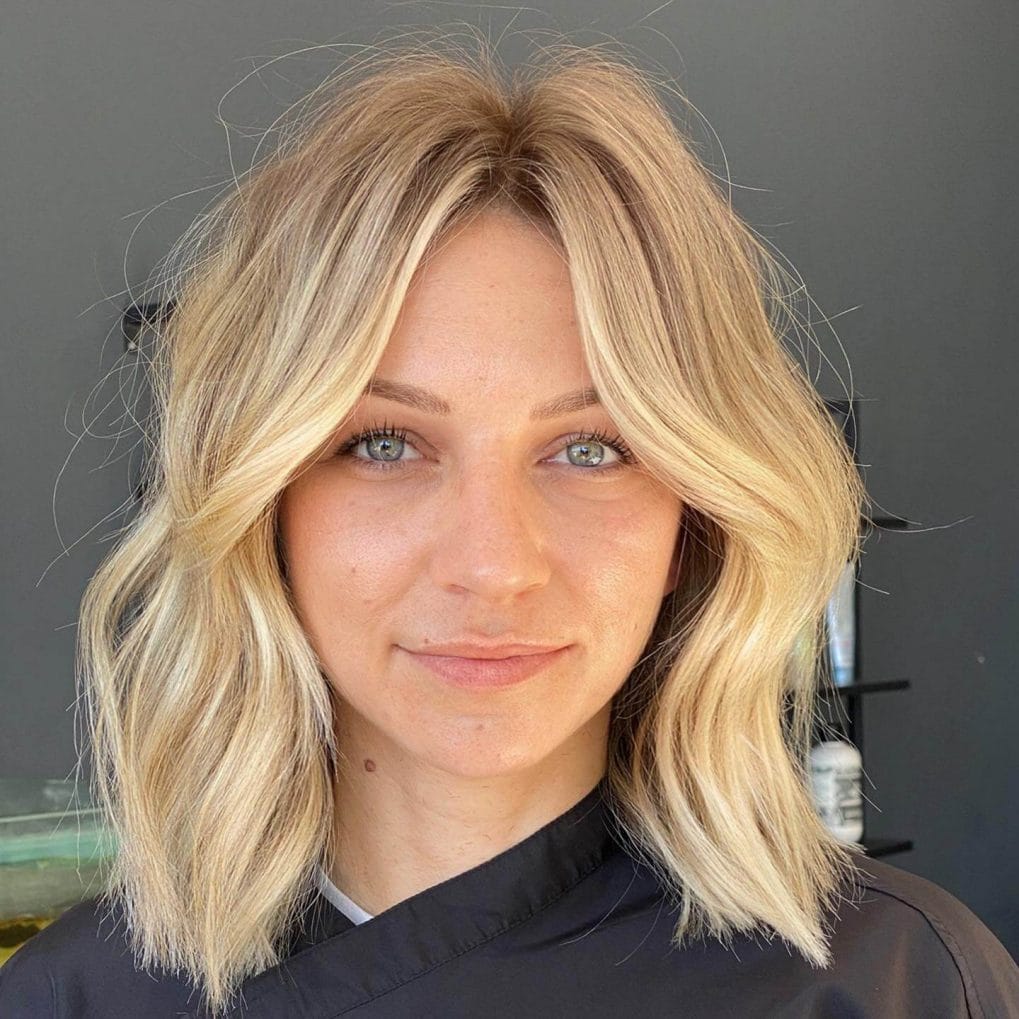 Blonde shoulder-length waves with sun-kissed undertones.