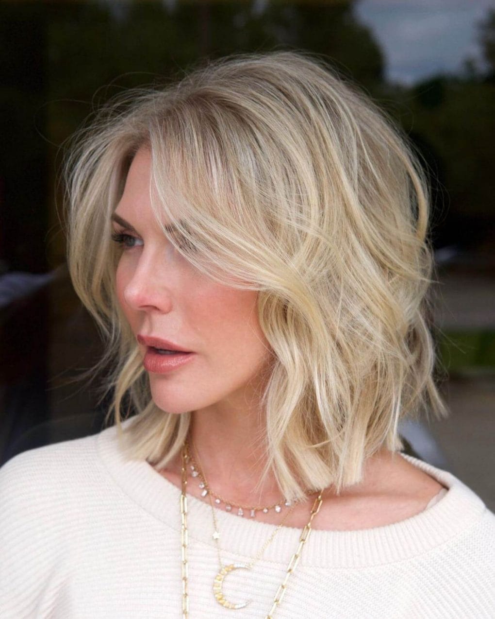 Tousled, sun-kissed blonde shoulder-length bob.