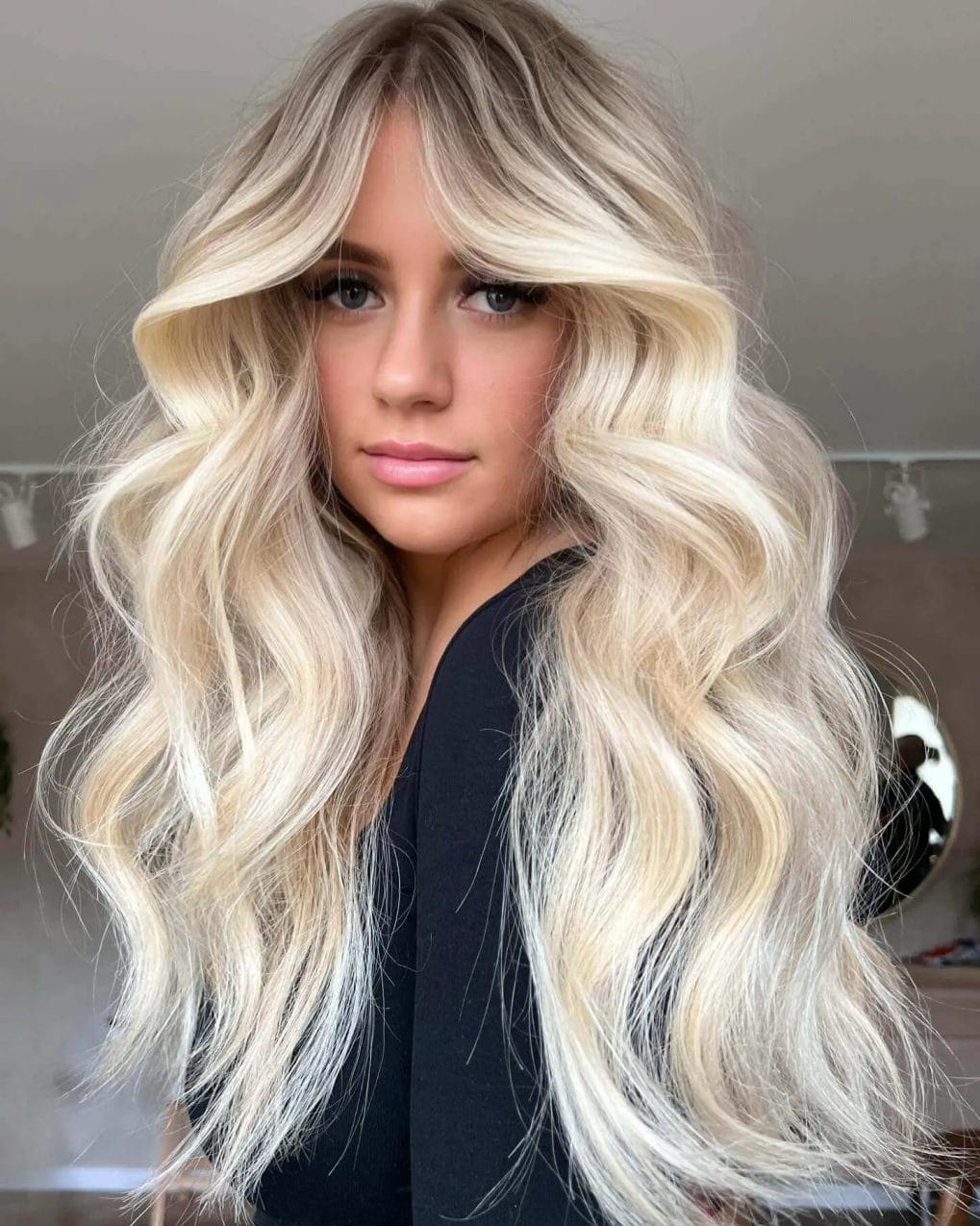 Beachy blonde waves with seamlessly blended curtain bangs