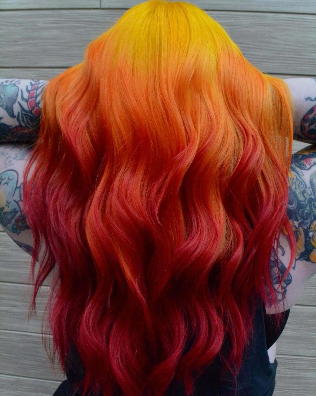 Bright yellow to bold red straight hair mimicking a summer sunset