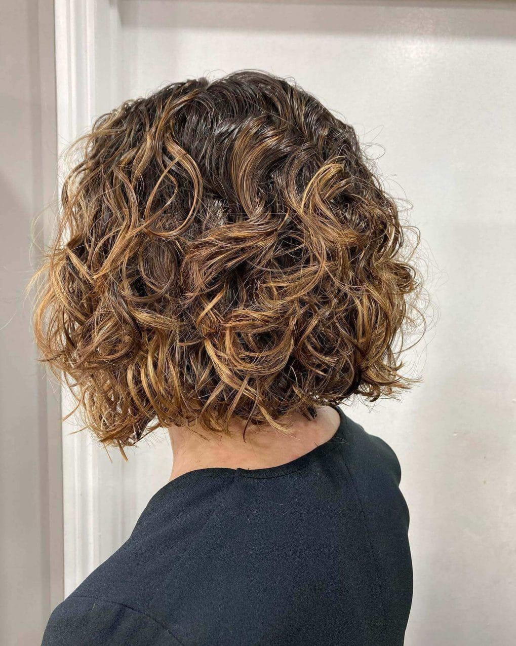 Textured bob with dark to light caramel highlights.
