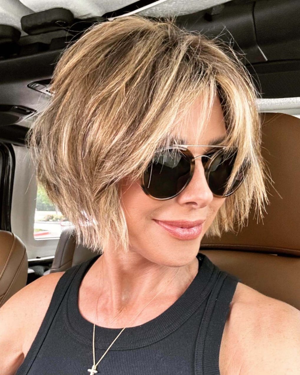 Textured, honey-blonde bob with thin, side-swept curtain bangs.