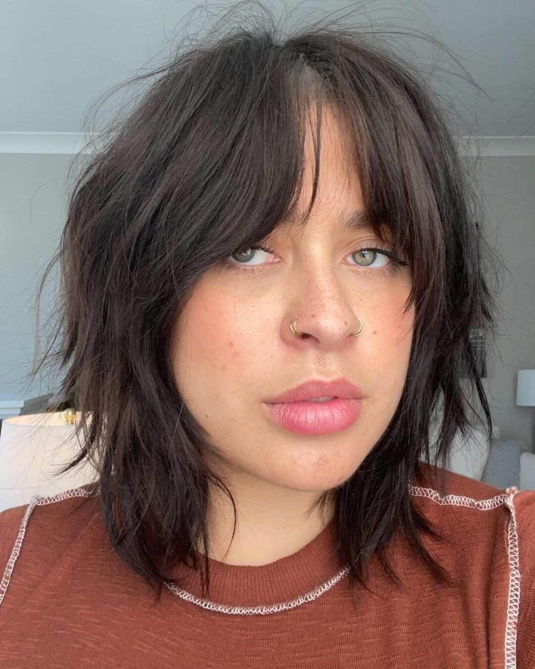 Textured tousled bob with trendy curtain bangs