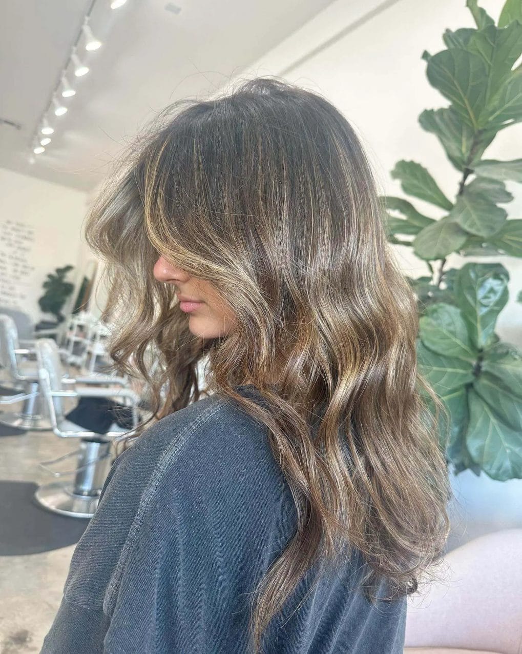 Textured waves with sun-kissed highlights on hair.