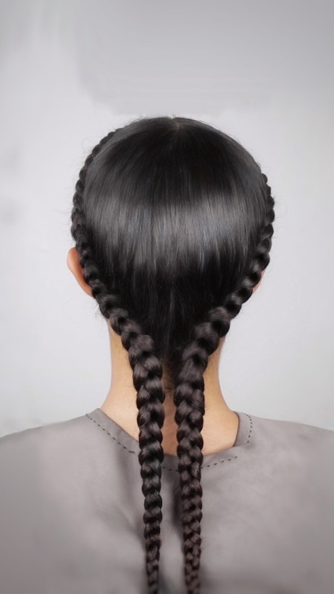 Pair of sleek, tight, dark braids perfect for softball gameplay