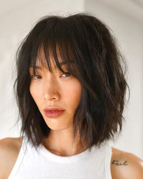 Tousled dark bob with chic see-through bangs