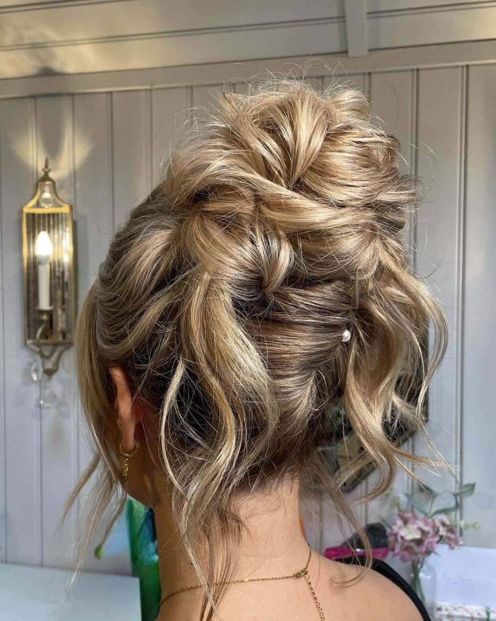 Romantic tousled high bun with golden blonde waves