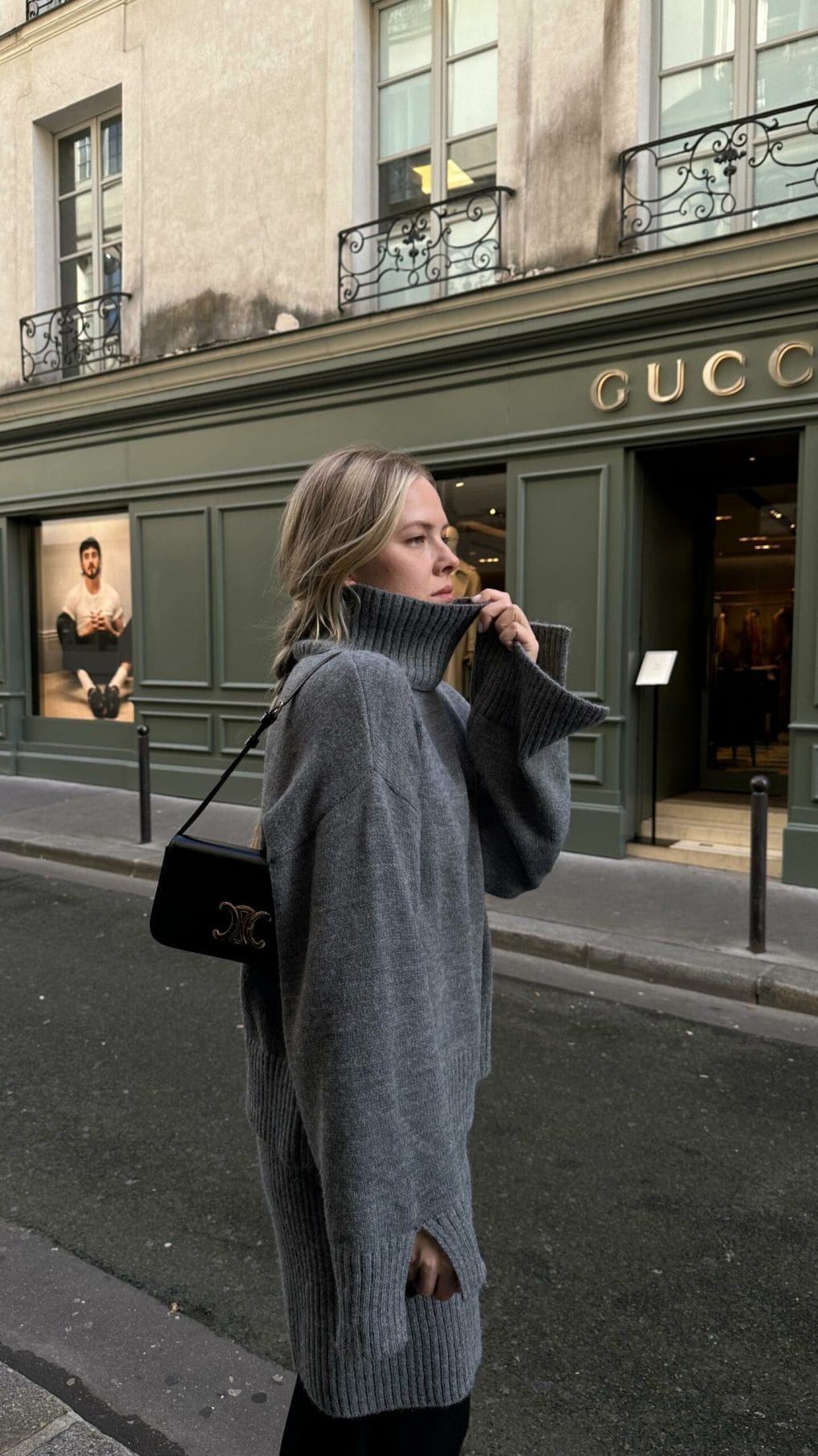 Sandy blonde long layered cut with tousled waves and a turtleneck sweater