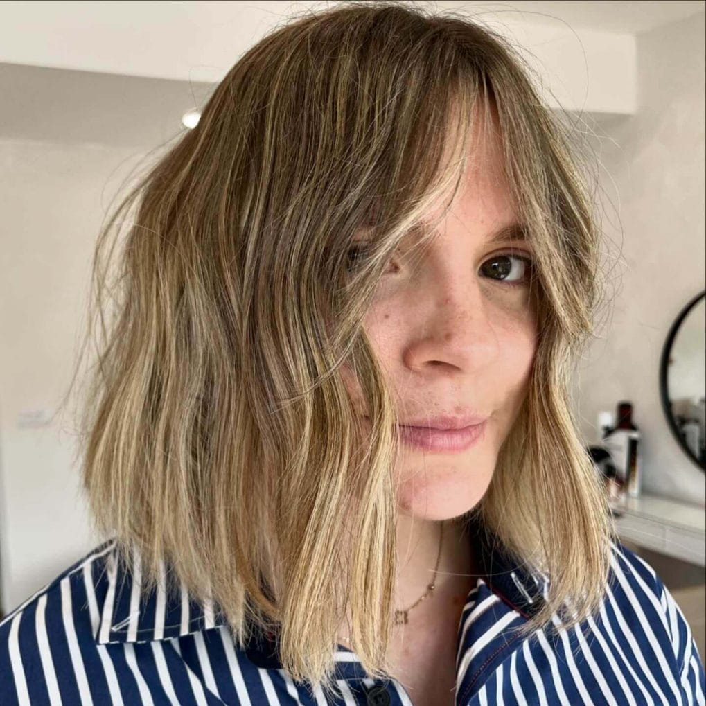 Tousled wavy bob with soft curtain bangs