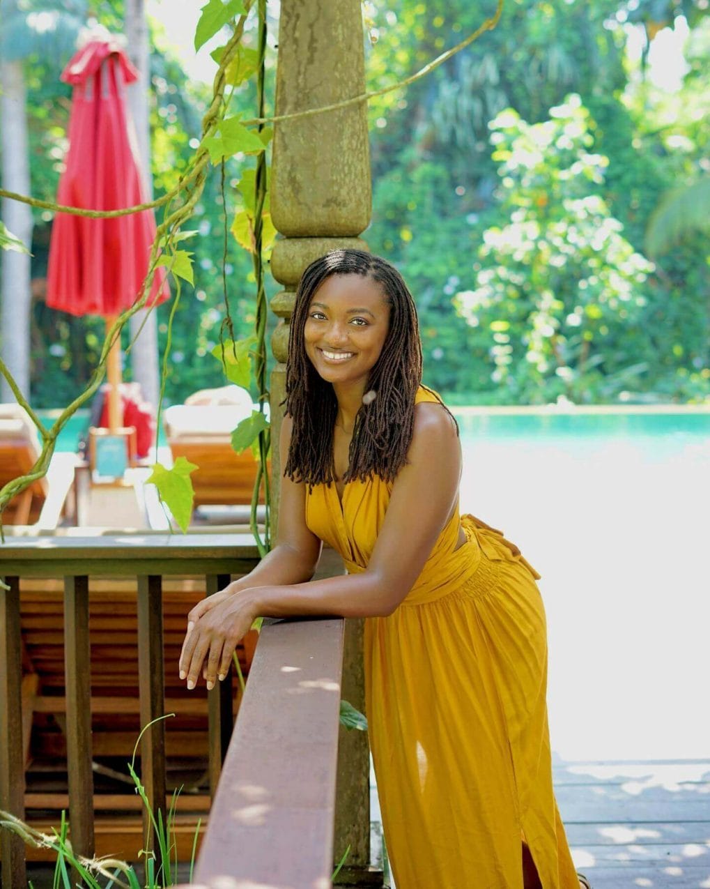 Honey-blonde twist locs falling past shoulders in a tropical vibe