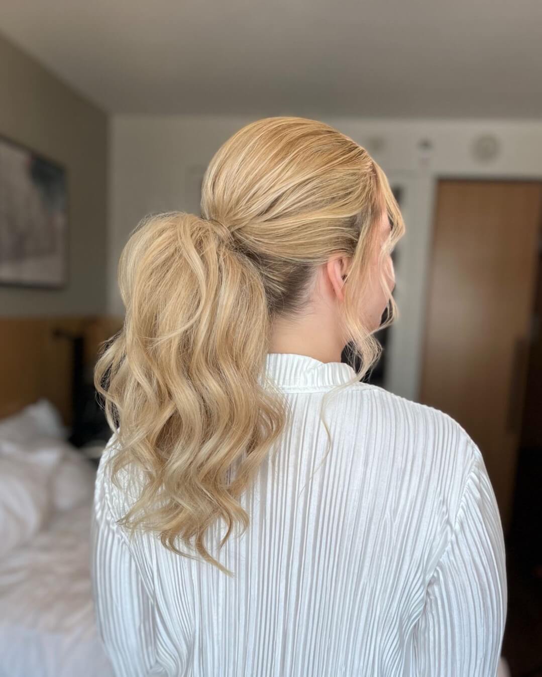 Ponytail with strands twirled at the base in blonde for a secure softball look