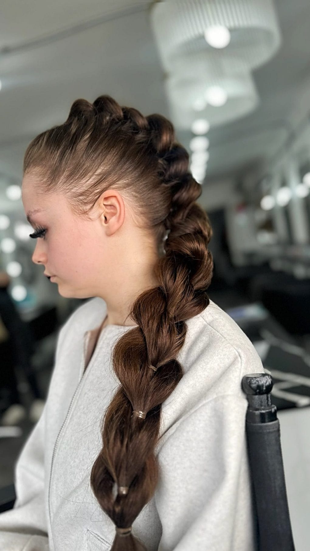 Chestnut brown thick twisted braid starting with tight cornrows for softball