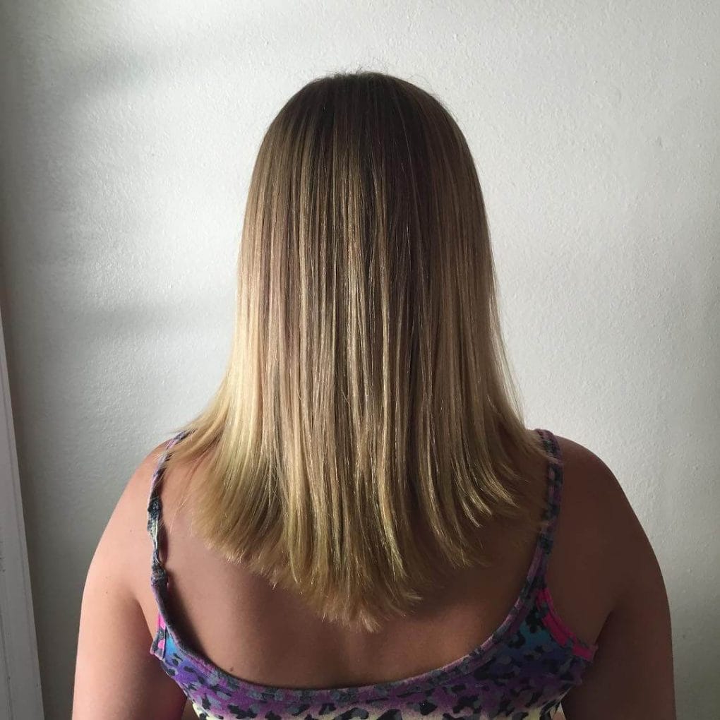 Revived blonde V-cut hairstyle with a fresh damage trim.