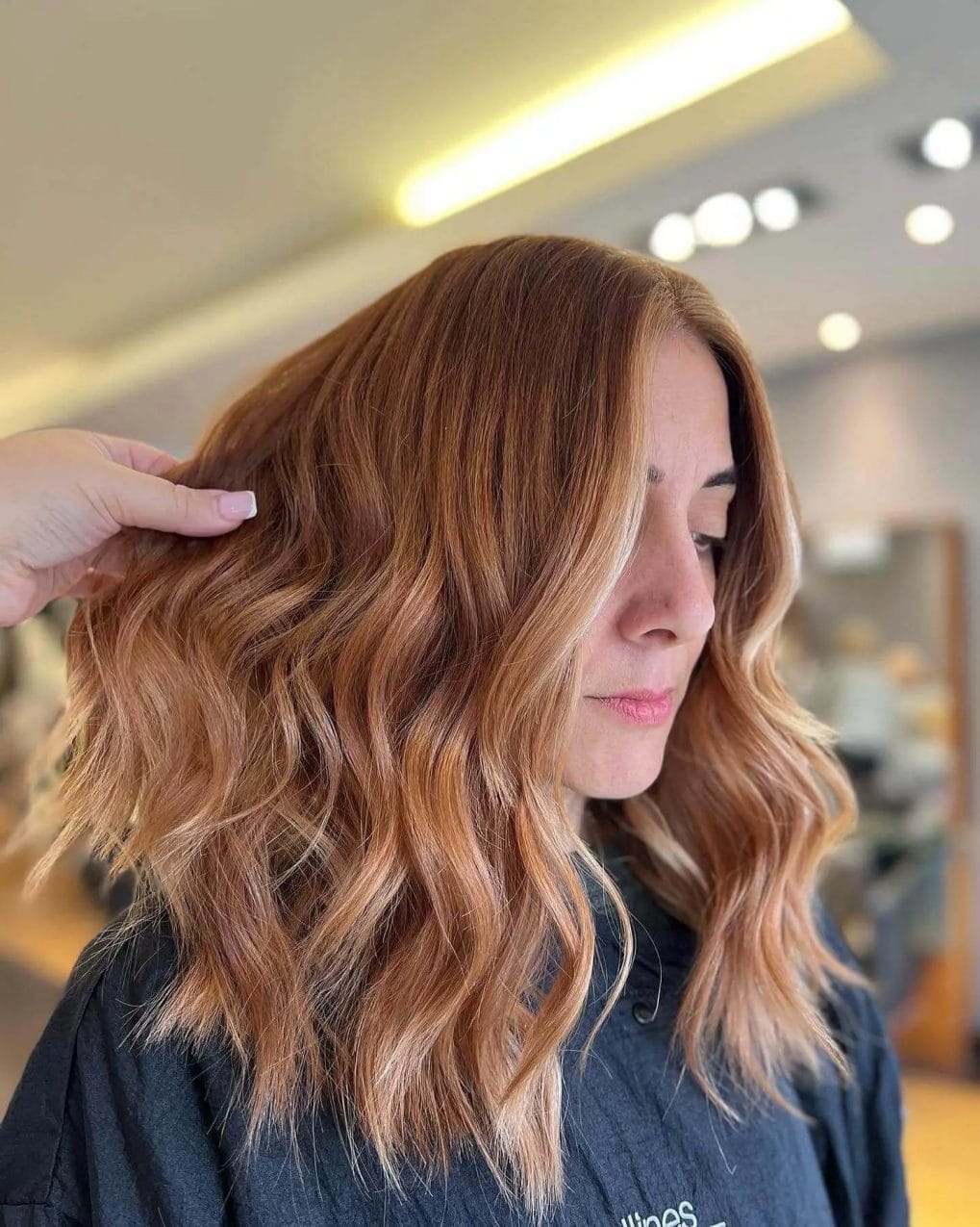 Vibrant copper balayage with soft waves, adding a fiery hue to the winter palette.