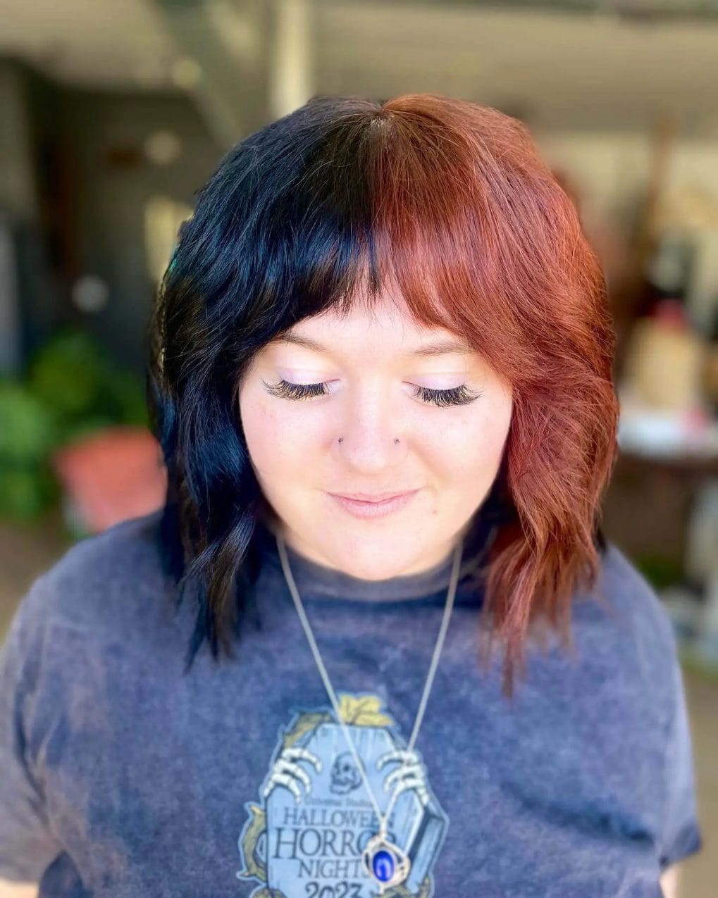 Striking copper to black transition shaggy bob with playful bangs