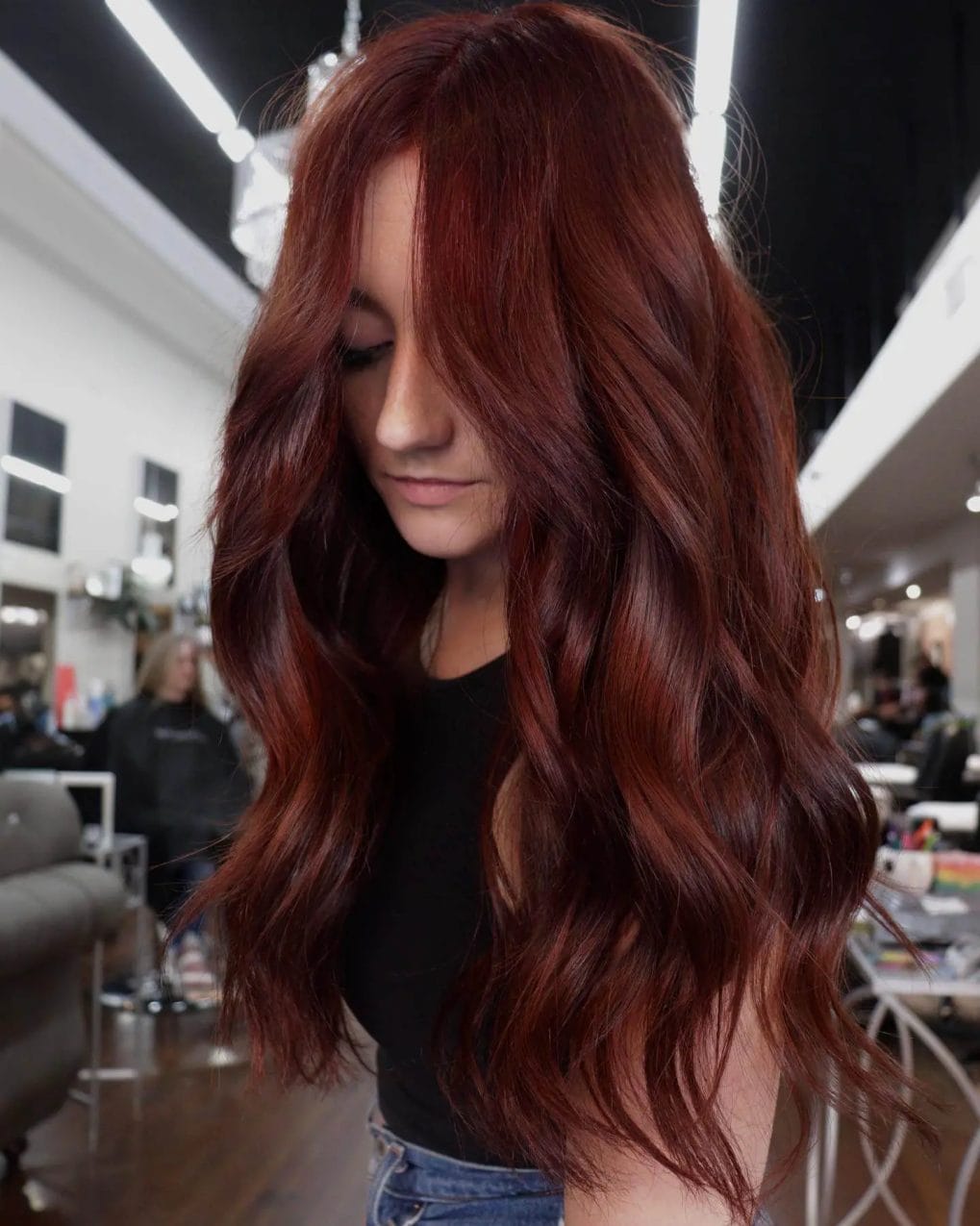 Vibrant copper hair with cascading waves and subtle layers.