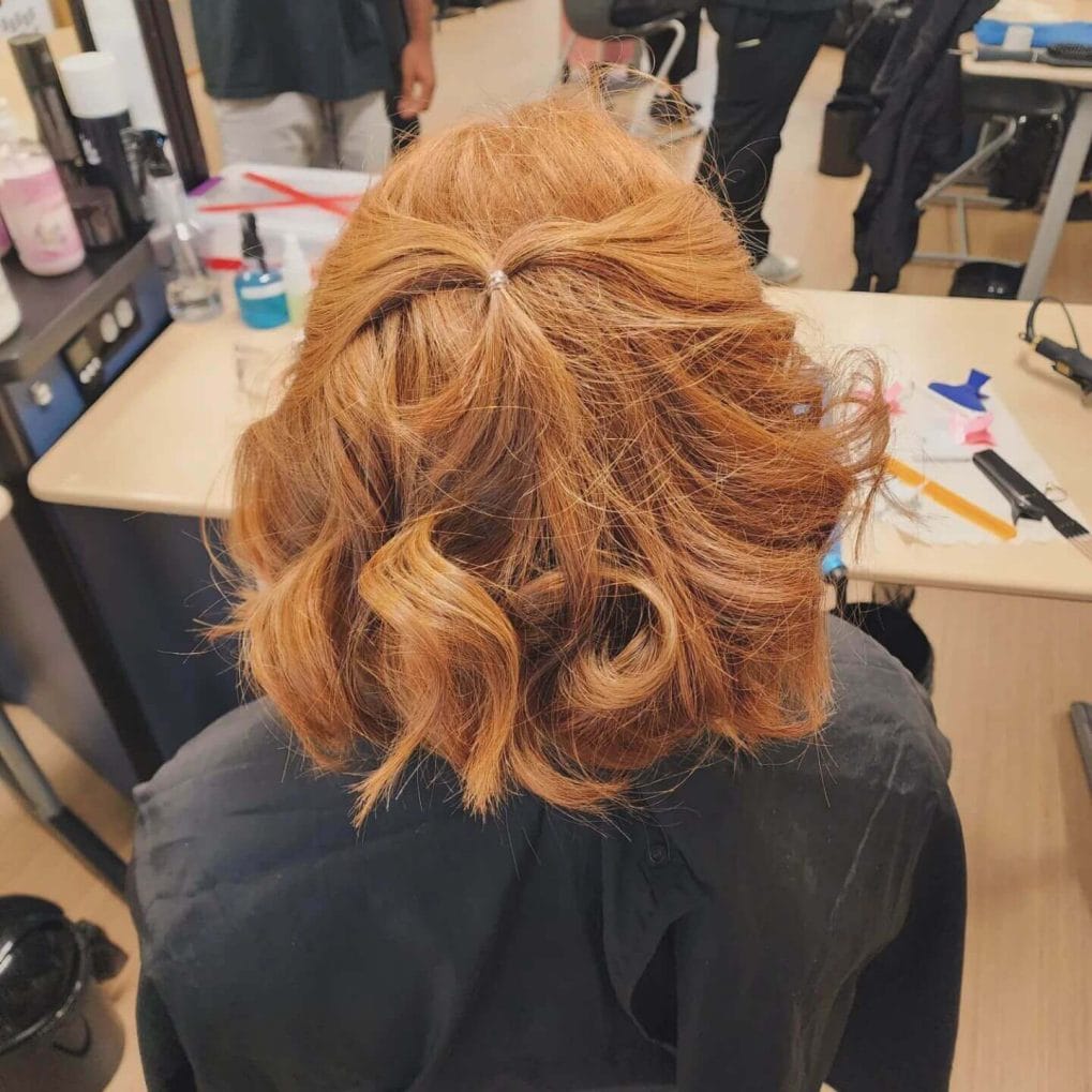 Vibrant curly bob with reddish-orange color