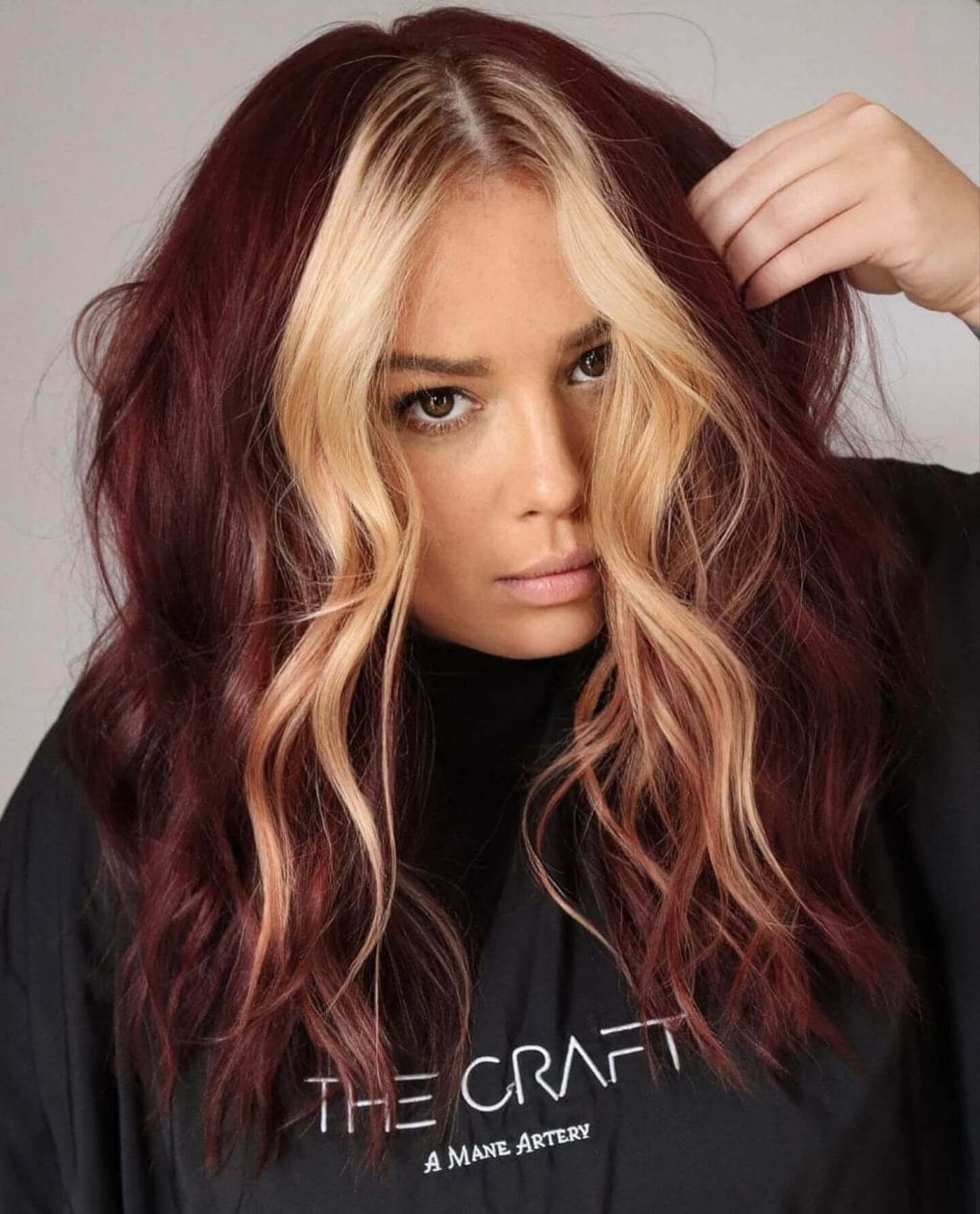 Dark roots with vibrant curled ends and bright money pieces
