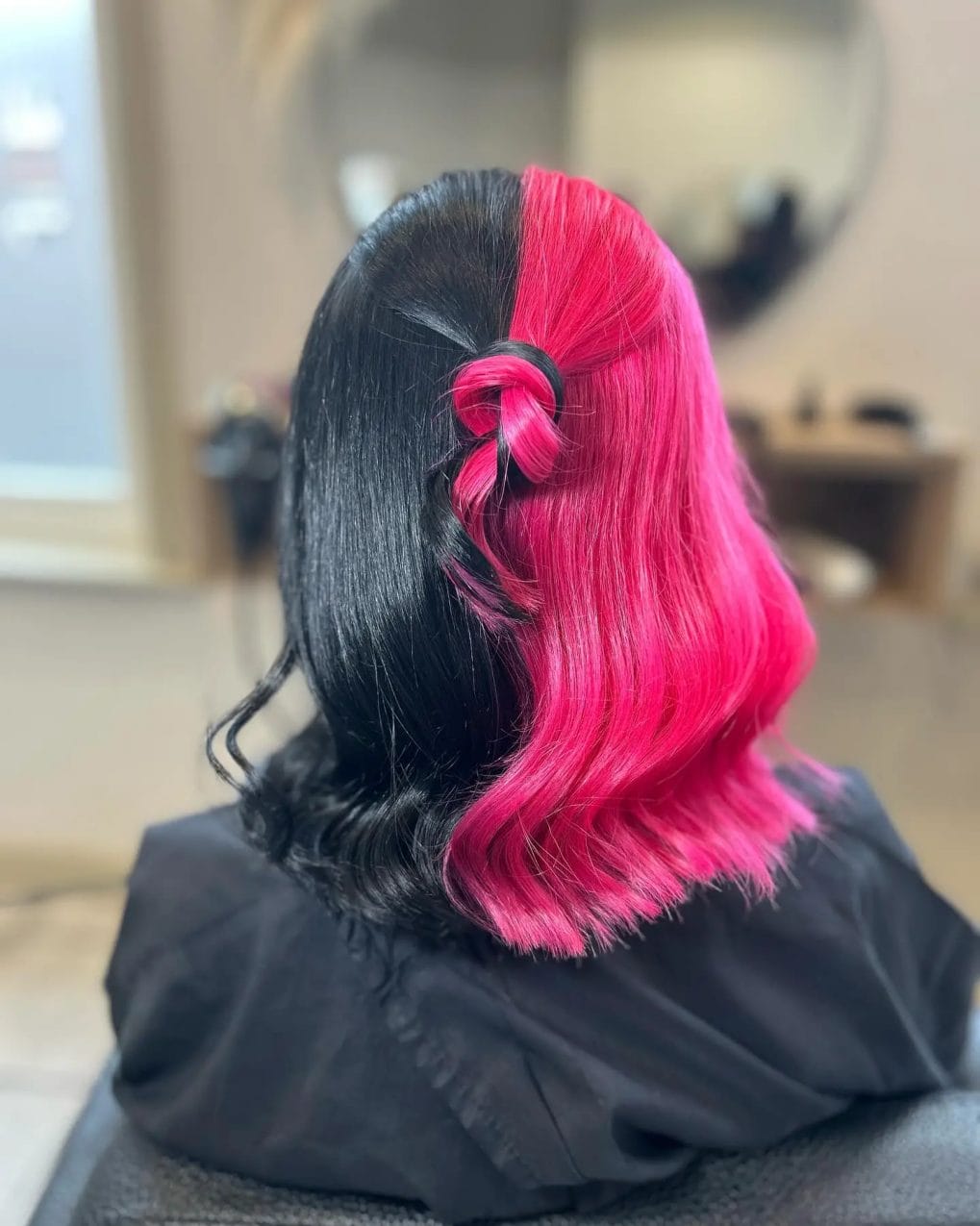 Vibrant pink and sleek black split in playful twist style