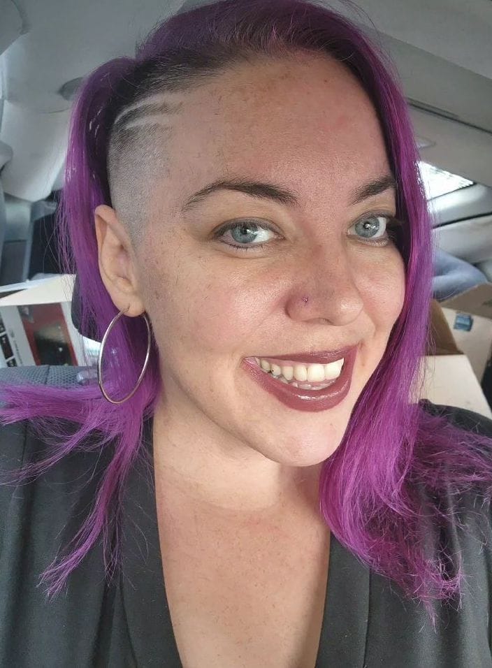 Bold asymmetrical with one shaved side and long purple waves