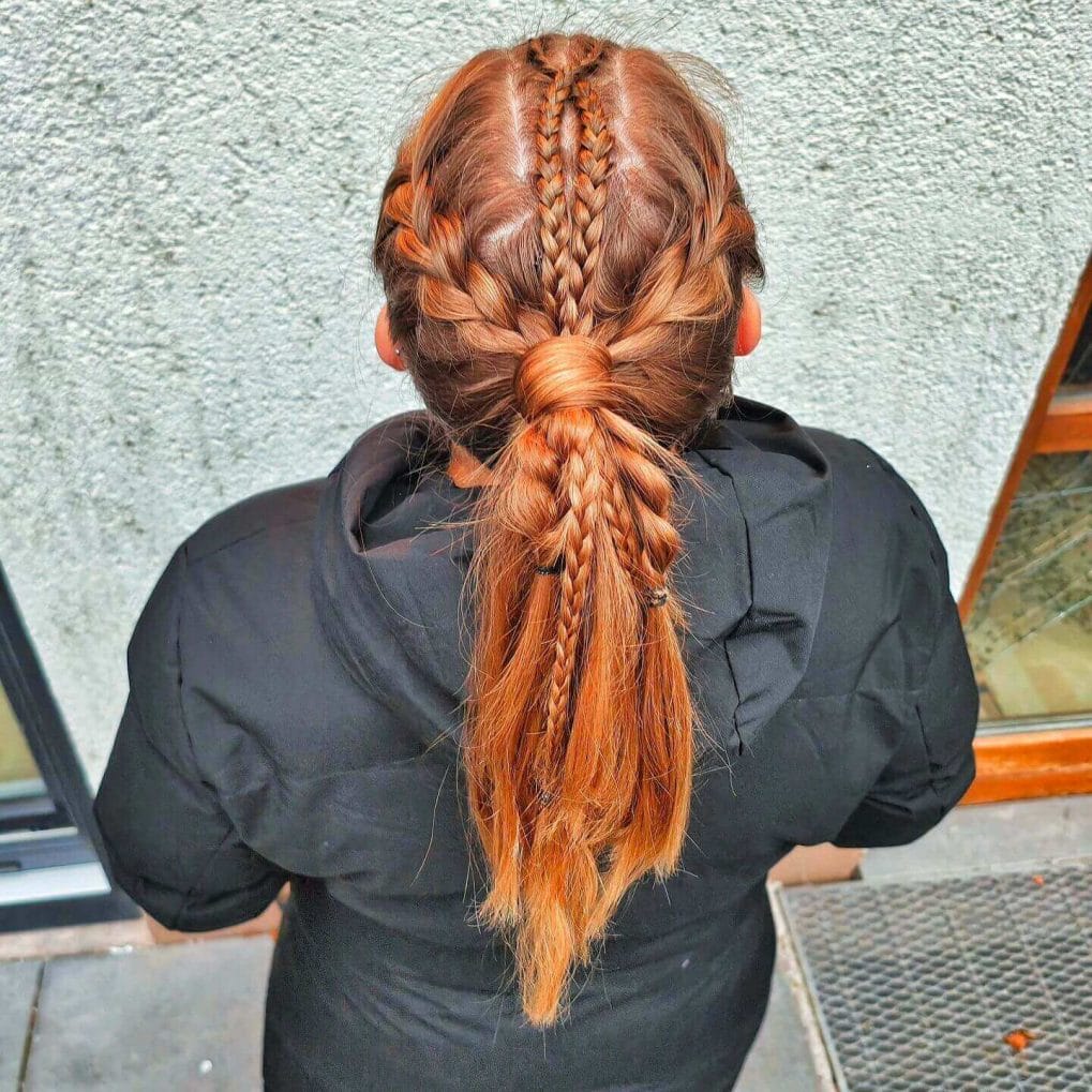 Bold red braided hairstyle blending textures for volleyball flair