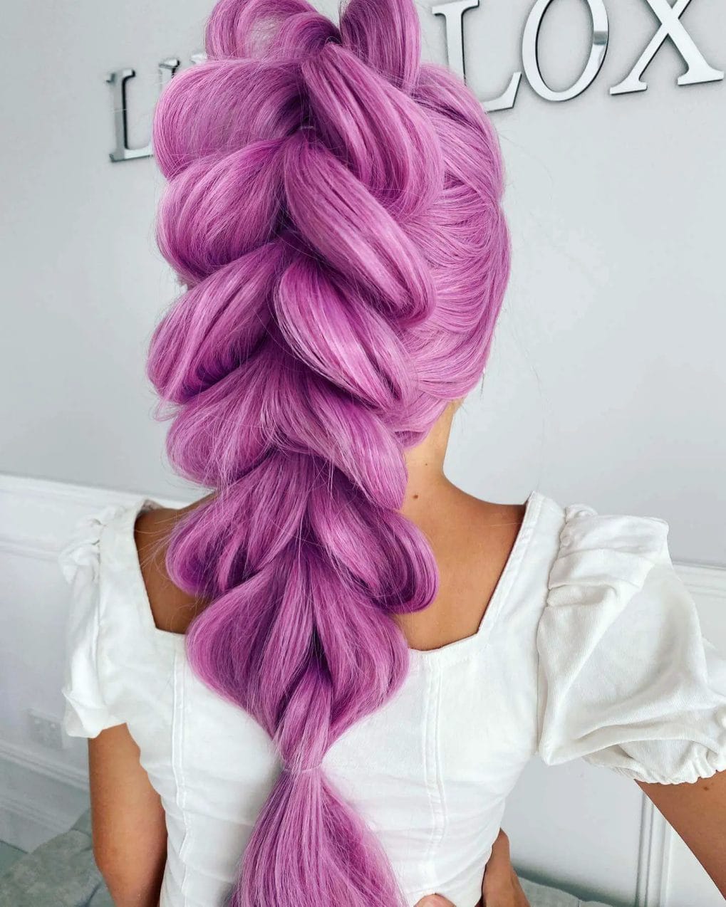 Vivid lilac bubble braid ponytail with voluminous loops for a playful look.