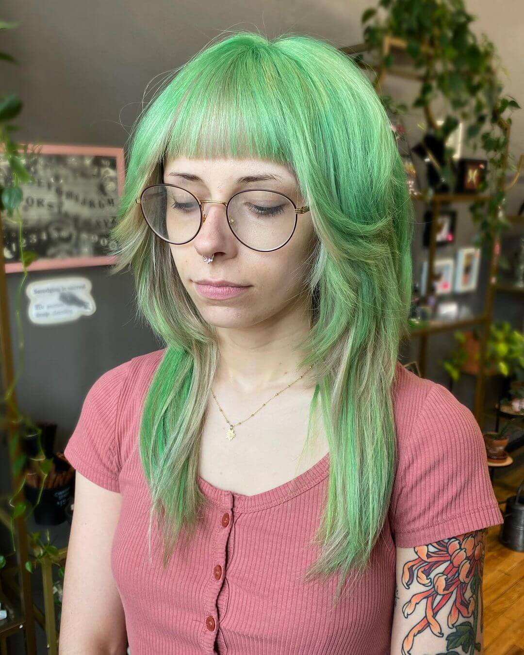 Bold lime green jellyfish haircut with a full straight fringe and soft, layered waves.