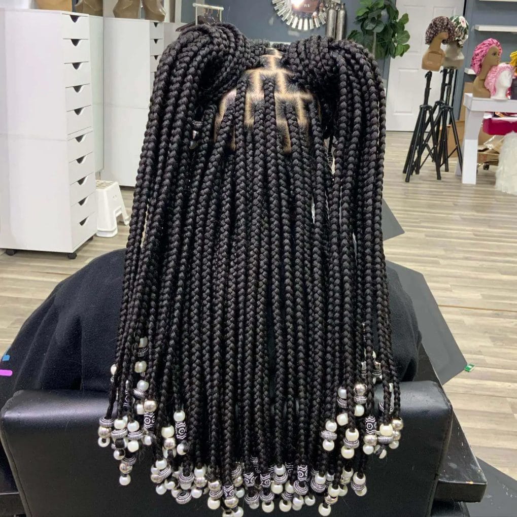 Voluminous jet-black braids with sophisticated silver and pearl bead pattern.