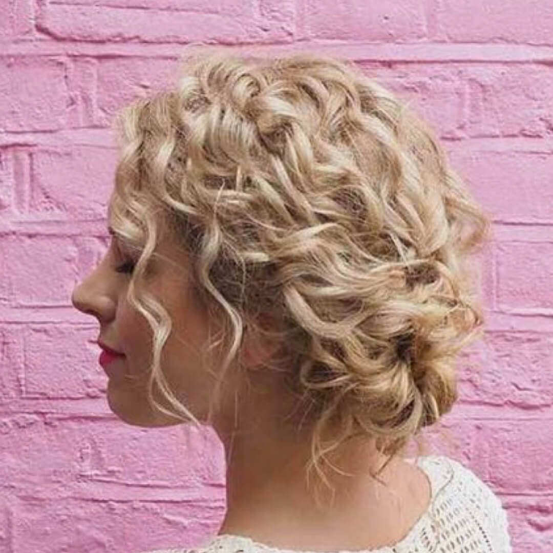 Voluminous blonde updo with playful curls