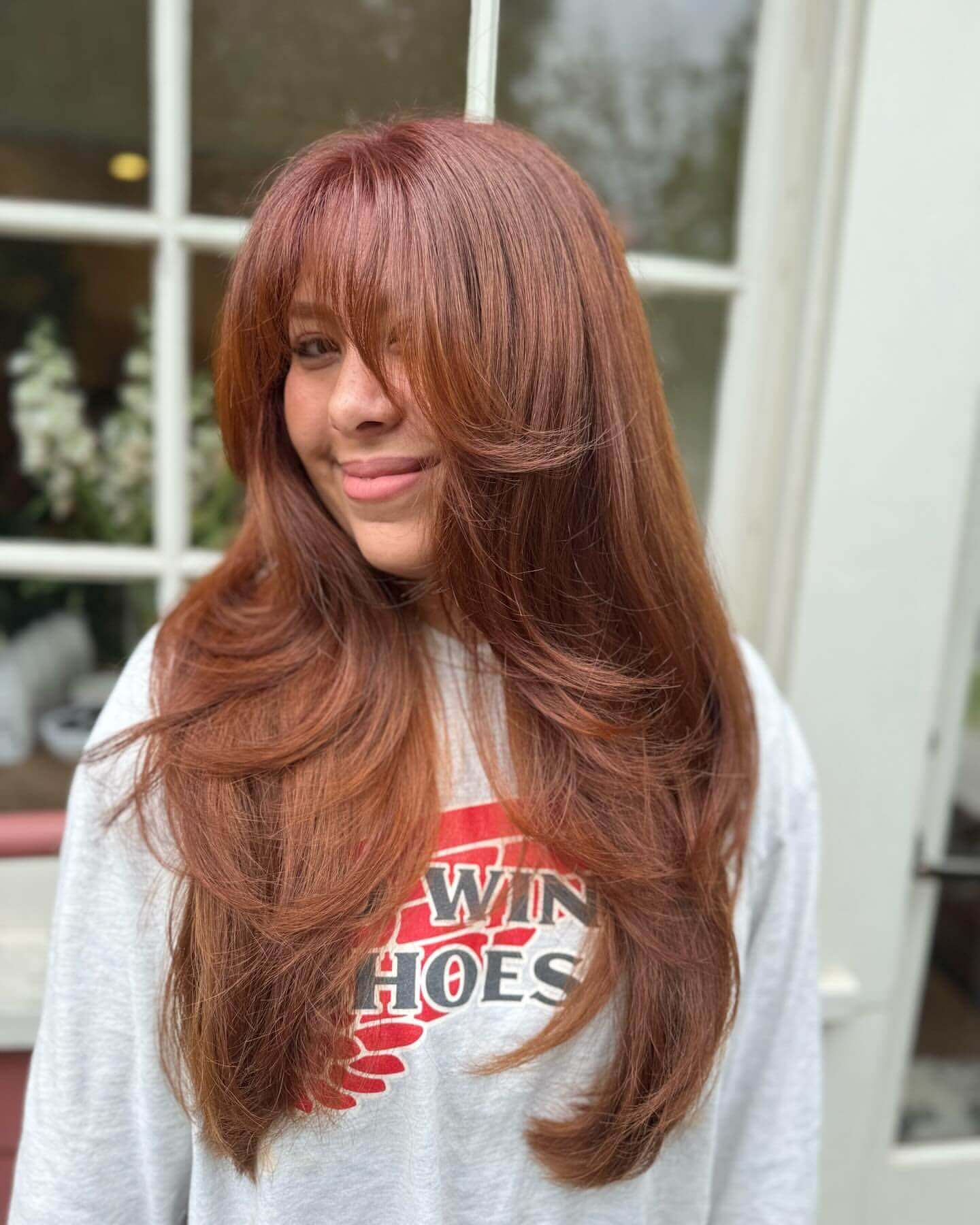 Voluminous copper hair with soft wispy bangs