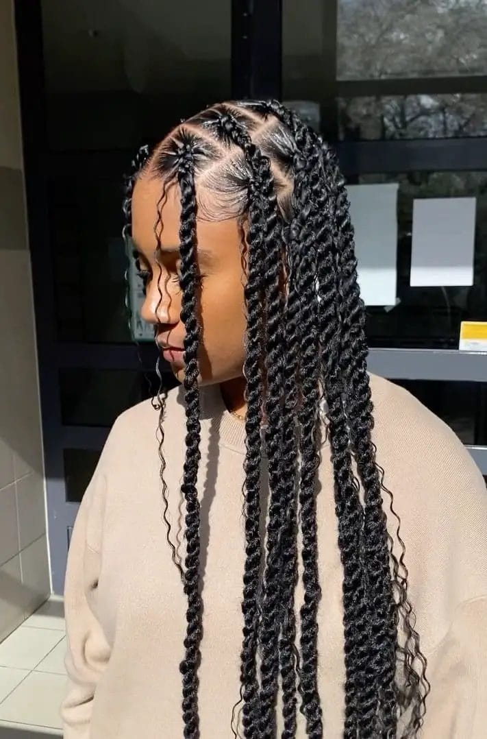 Extra-long kinky twists with a clean zigzag part down to the waist