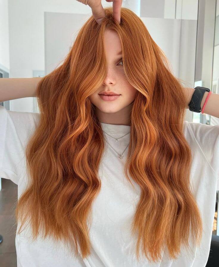 Warm copper waves with curtain bangs