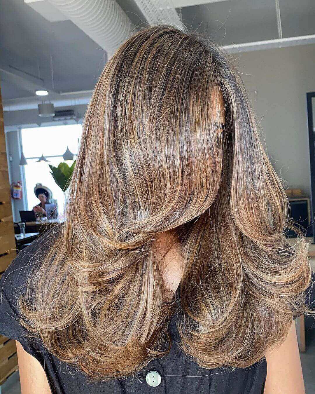 Warm summer brunette Butterfly Cut with a hint of Scandi hairline fusion.