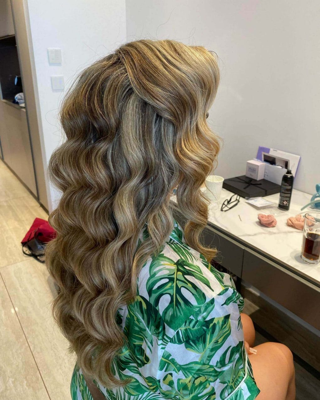 Wavy balayage hair with subtle blonde and brown highlights.