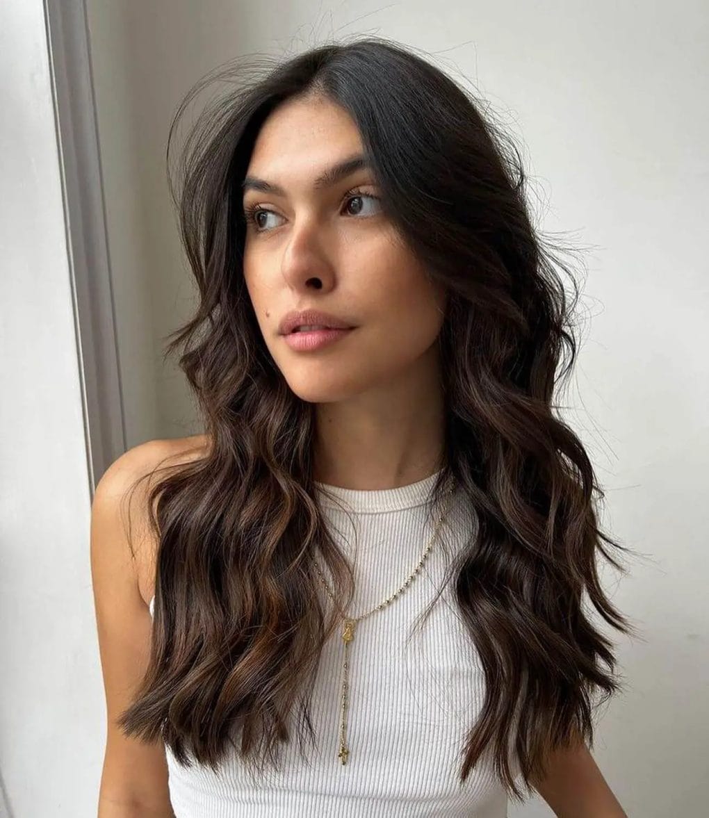 Butterfly Cut transforming straight hair into layered waves.